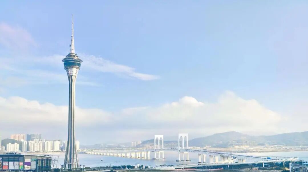 阿图什天门自然石拱门, 巨大的石拱门矗立在蓝天下, 四周是荒凉而壮美的戈壁山景, 光影强烈, 充满震撼力的自然奇观